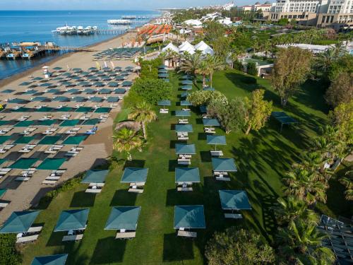 an aerial view of a beach with a bunch of umbrellas at Kaya Belek in Belek