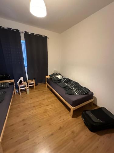 a room with two beds in a room with a wooden floor at Domum 2 Moderne Ferien- Monteurapartments inkl Wlan und Waschmaschine in Gelsenkirchen in Gelsenkirchen