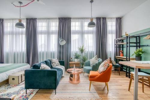 a living room with green furniture and a table at PH Hostel Birmingham in Birmingham