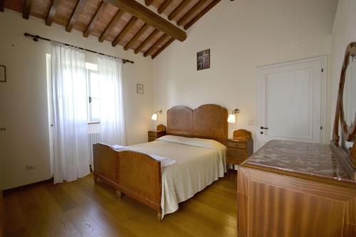 Lova arba lovos apgyvendinimo įstaigoje Villa Il Palazzone