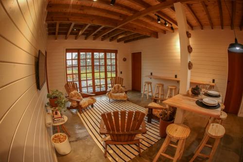 una sala de estar con mesa y sillas en una casa en Skyline Urubici - Barn, en Urubici