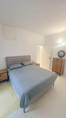 a bedroom with a bed with a blue blanket at Aggelos Apartment Central in Antiparos in Andiparos