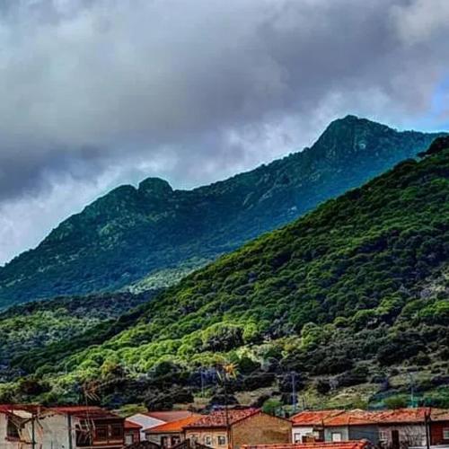 a mountain with a town in front of it at Spacious house in Cenicientos with mountain view in Cenicientos