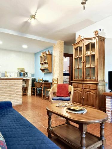 a living room with a table and a kitchen at Spacious house in Cenicientos with mountain view in Cenicientos