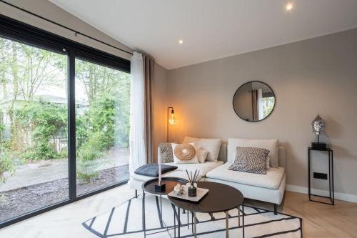 a living room with a couch and a table at Veluwe Boutique Lodge in Putten