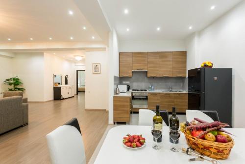 een keuken en een woonkamer met een tafel met een fruitmand bij Premium 2 Bedroom Apartment lll in Tbilisi City