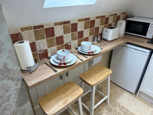 a kitchen counter with two cups and saucers on it at ElMurrs in Bournemouth