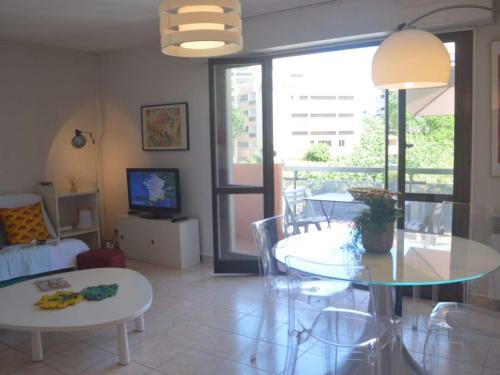 un salon avec une table et une salle à manger dans l'établissement Appartement à 5 min de la plage avec terrasse et parking - Fréjus - FR-1-226A-106, à Fréjus