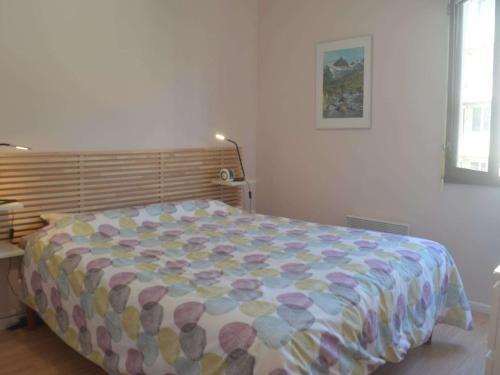 - un lit avec une couette colorée dans une chambre dans l'établissement Appartement à 5 min de la plage avec terrasse et parking - Fréjus - FR-1-226A-106, à Fréjus