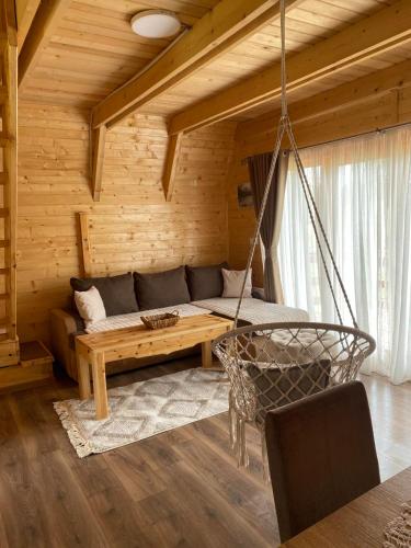 a living room with a couch and a swing at Villa Wood Borje in Žabljak