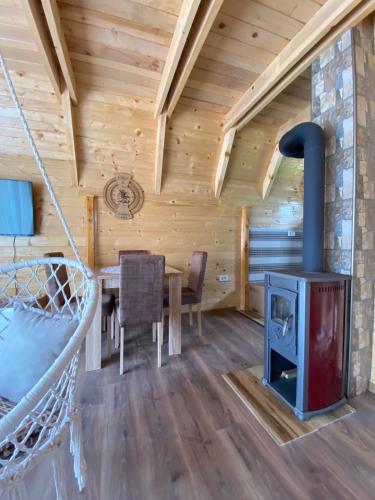 a log cabin dining room with a wood stove at Villa Wood Borje in Žabljak