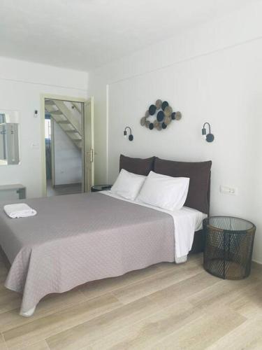 a bedroom with a large bed and a mirror at Ocean Sun 3 in Éxo Goniá