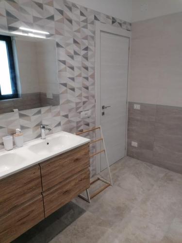 a bathroom with a sink and a shower with a ladder at Casa Don Peppì in Monopoli
