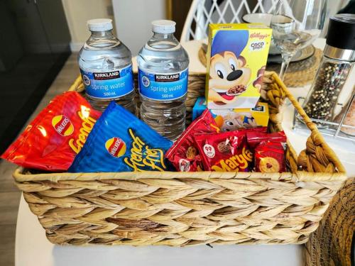 a basket filled with snacks and water bottles on a table at Abbeydale Place-Spacious one bedroom flat in Heeley