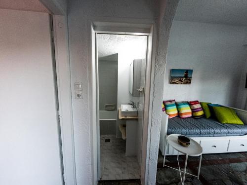 a small bedroom with a bed and a mirror at Tea & Sea Apts in Anissaras