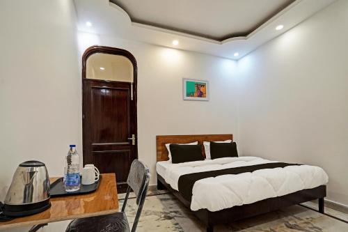 a bedroom with a bed and a table and a mirror at OYO Kiiza Stay House in New Delhi