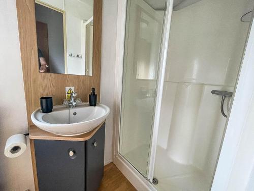 a bathroom with a sink and a shower at 6 Berth Caravan With Free Wi-fi At Dovercourt Holiday Park In Essex Ref 44009c in Great Oakley