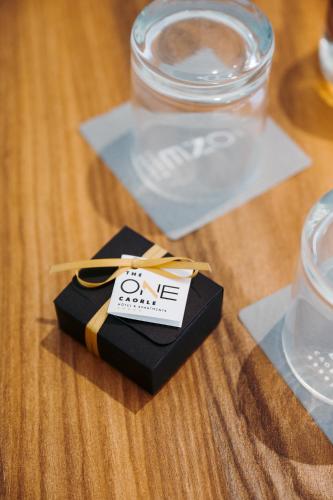 a black box with a tag on it on a table at THE ONE CAORLE - Hotel & Apartments in Caorle