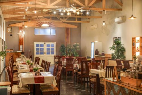 a restaurant with tables and chairs in a room at Hotel SunGrace in Mussoorie