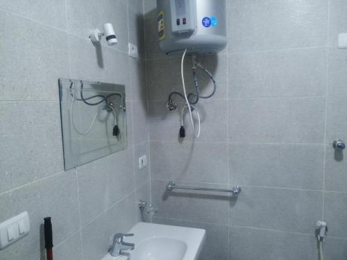 a bathroom with a sink and a mirror at Marvel apartment in Quseir