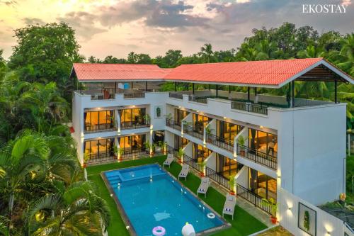 an aerial view of a house with a swimming pool at Ekostay Gold Sea Shore Villa I Rooftop Turf I 100 Meters away from the Beach in Alibaug