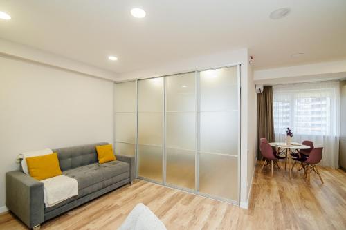 a living room with a couch and a table at Cozy Apartment - 4th Floor in Chişinău