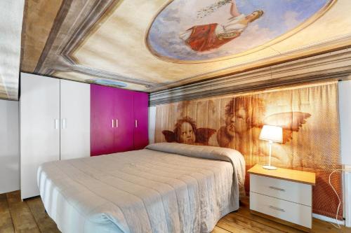 a bedroom with a bed with a painting on the ceiling at Antro Di Circe - Orta Centro in Orta San Giulio