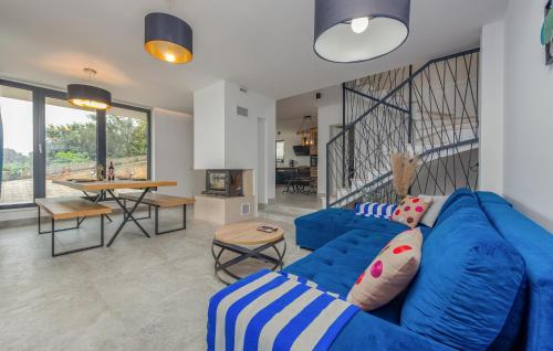 a living room with a blue couch and a table at Lovely Home In Kali With Wifi in Kali