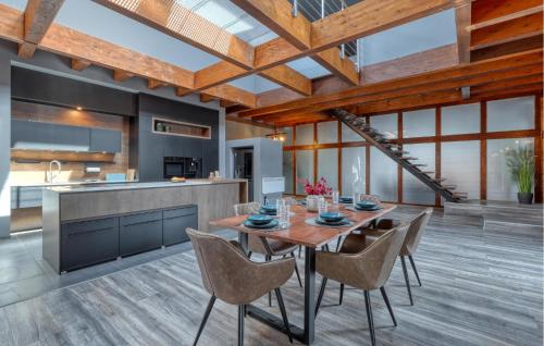 a kitchen and dining room with a wooden table and chairs at Luxusvilla Mit Kegelbahn in Bahrdorf