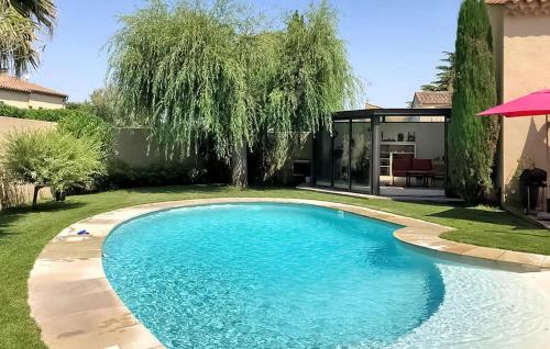 a swimming pool in the yard of a house at La Villa De Sévigné in Rognonas