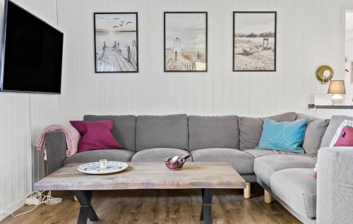 a living room with a couch and a coffee table at 2 Bedroom Stunning Home In Jægerspris in Jægerspris