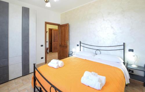 een slaapkamer met een groot oranje bed met handdoeken erop bij 2 Bedroom Nice Home In Porchiano in Porchiano