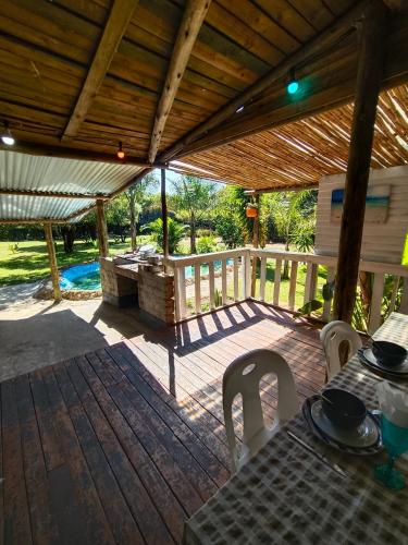 a wooden patio with a table and a wooden roof at Shangrila-innibos Country Lodge in Hartbeespoort
