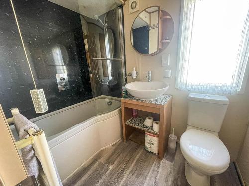 a bathroom with a sink and a toilet and a tub at Great 4 Berth Caravan For Hire In Suffolk At North Denes, Ref 40149nd in Lowestoft
