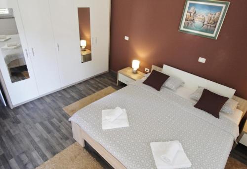 Ένα ή περισσότερα κρεβάτια σε δωμάτιο στο Apartments Titonel