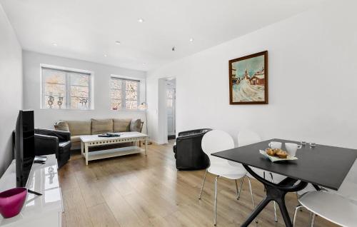 a living room with a couch and a table at Nice Apartment In Gilleleje in Gilleleje