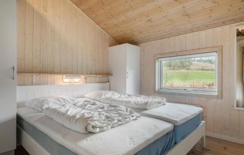 two beds in a small room with a window at Cozy Home In Silkeborg With Wifi in Silkeborg