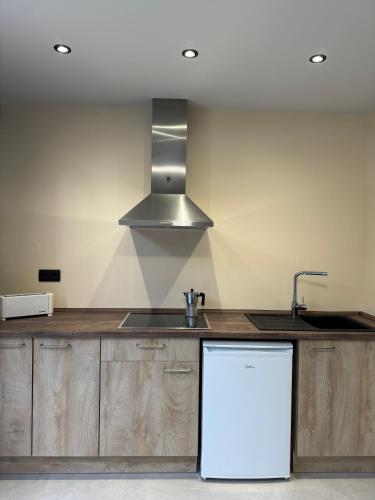 a kitchen with a sink and a stove top oven at Camping Fonts del Algar in Callosa de Ensarriá