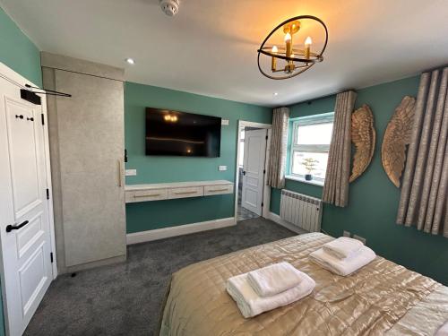 a bedroom with a bed and a flat screen tv at Swish Luxury Holiday Apartments in Blackpool