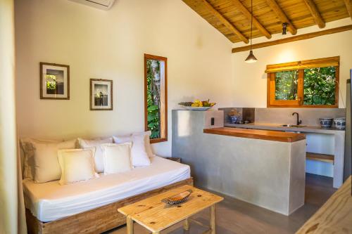 a living room with a couch and a table at Pousada Vila Biribiri Trancoso in Trancoso