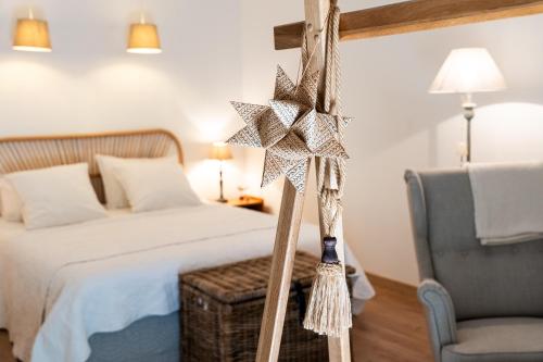 1 dormitorio con 1 cama, 1 silla y 1 estrella en La petite madeleine - Chambre d'hôtes & spa, en Burgy