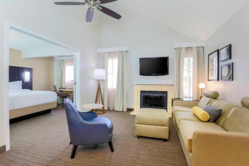 a hotel room with a living room with a couch and a bed at Residence Inn Boston North Shore/Danvers in Danvers