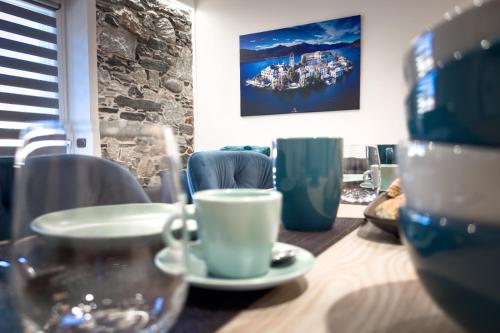 a table with a cup and a plate on it at Lakes and Mountains Magic Holiday House in Omegna