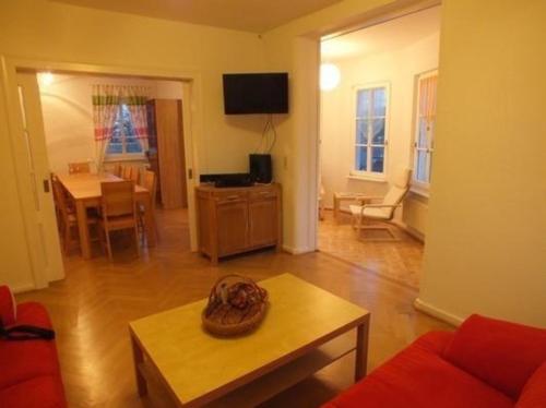 a living room with a couch and a table at Ferienhaus im Thüringer Wald mit Grill und Garten in Schwarzatal
