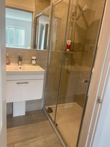 a bathroom with a shower and a sink at 12 Ganderhill in Haywards Heath