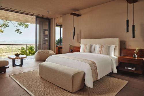 a bedroom with a large bed and a large window at One&Only Mandarina in Lo de Marcos
