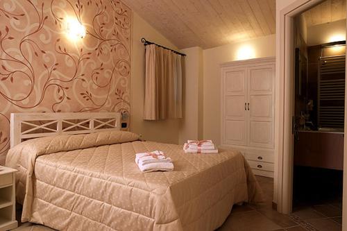 Postel nebo postele na pokoji v ubytování Agriturismo Il Barone