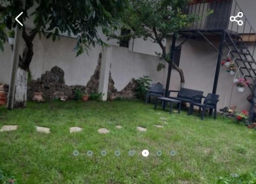 a yard with two chairs and a table in the grass at Acasa in Năvodari