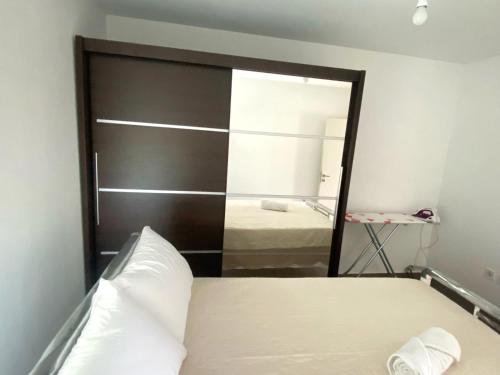 a bedroom with a large mirror and a bed at Stone House in the foothills of Taygetos in Xirokámbion