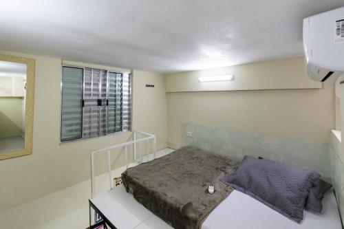 a small bedroom with a bed and a window at 37 LOFT TRIPLO · Congonhas Airport, Jabaquara Metro, Expo São Paul in Sao Paulo